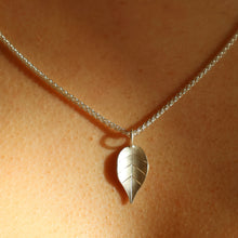 Load image into Gallery viewer, close up of delicate silver leaf pendant on silver spiga chain
