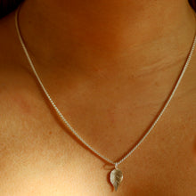 Load image into Gallery viewer, Delicate silver leaf pendant on chain on  a person.

